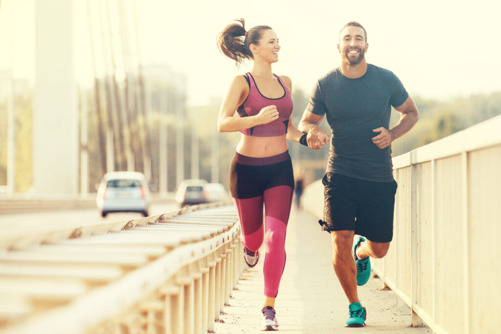 A photo of a happy couple jogging.