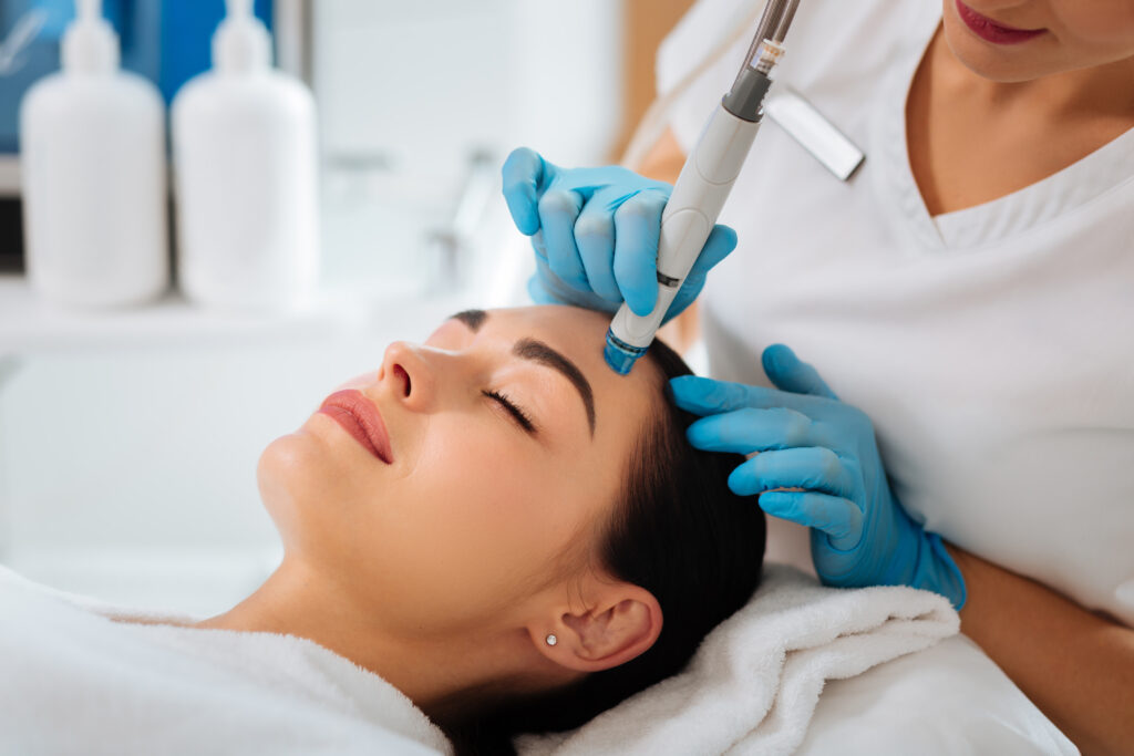 A photo of a woman getting a Hydrafacial.