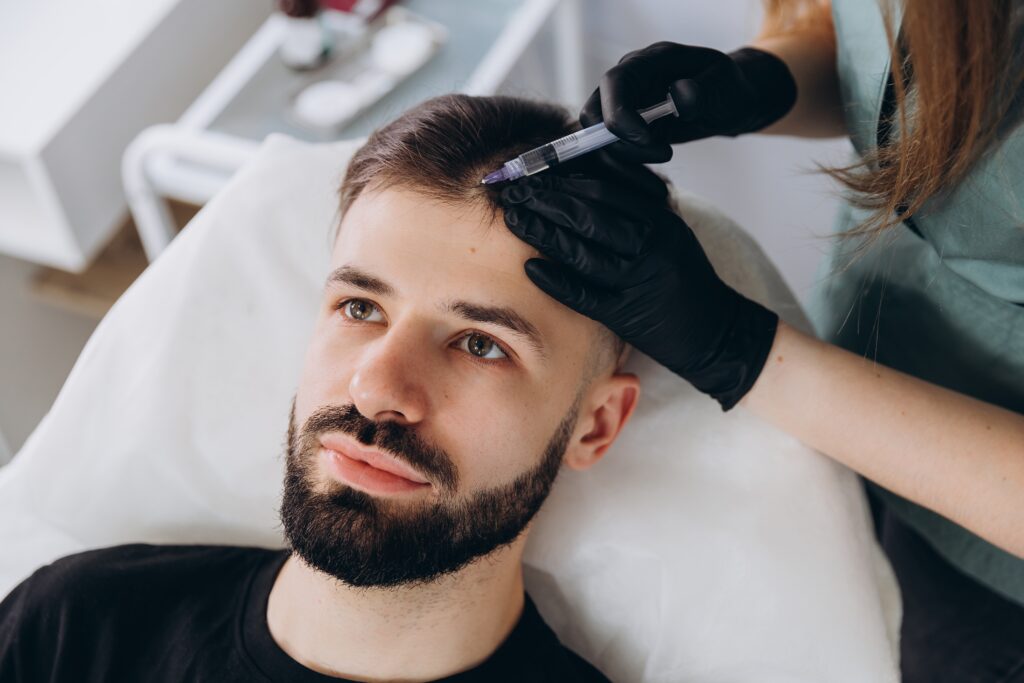 A photo of a man getting hair restoration treatment